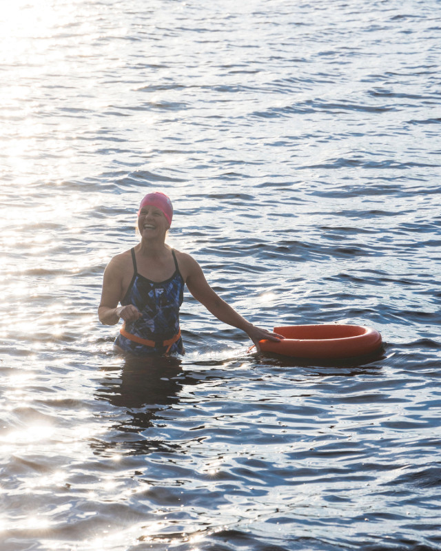 Woman in the lake during a wild swim camp, Ullswater