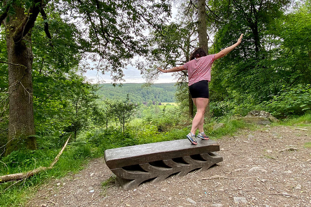 woman walking on bench sculpture