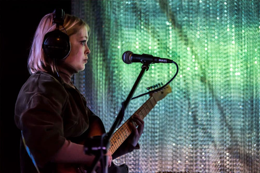 Image of a person playing the guitar 