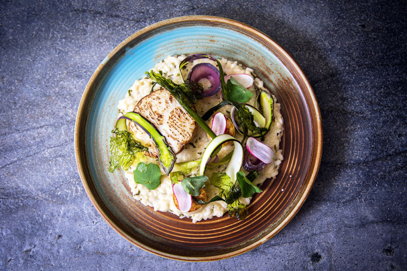 Brown butter poached hake spring vegetables and herb risotto