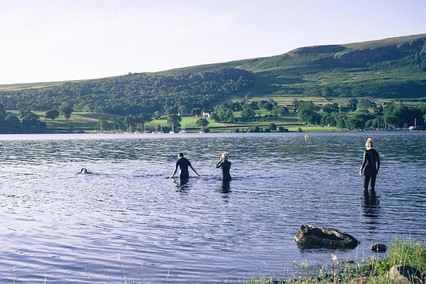 Group of swimmers entering the water