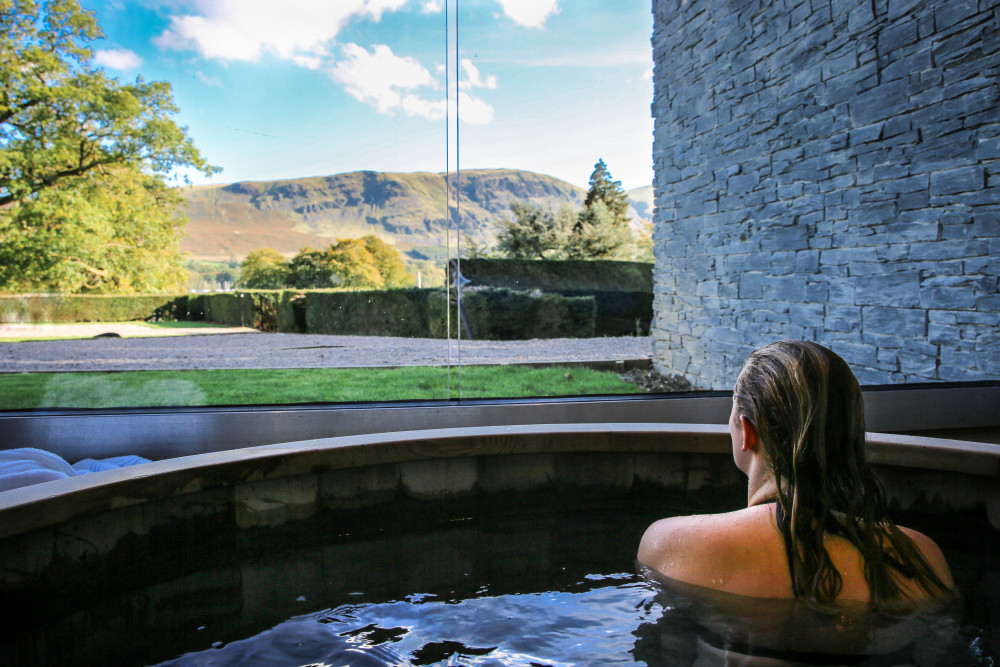 Woman in the hot tub overlooking the fells