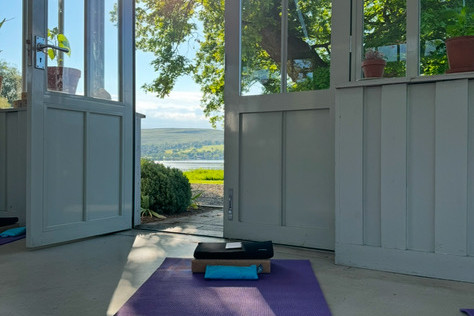 Yoga set up by the door in the Glasshouse at Another Place, The Lake