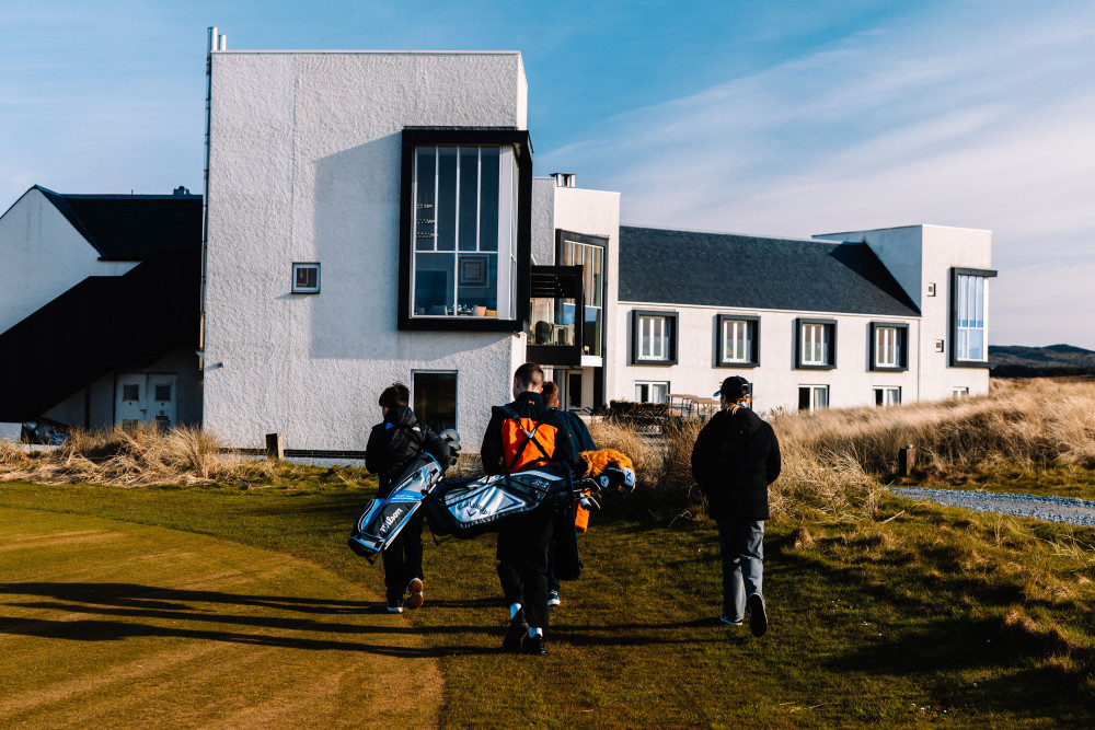 Young golfers at The Machrie, Islay heading back to the hotel from the course