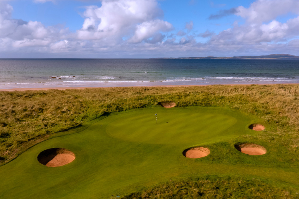 Aerial shot of the 9th hole of The Machrie, Islay golf course, looking out over the sea