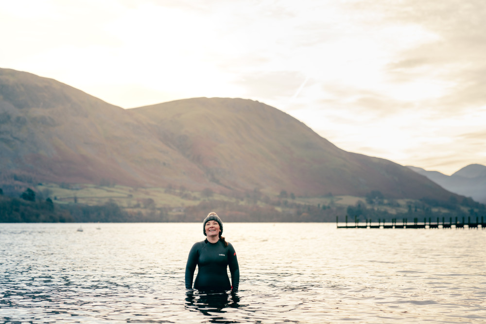 Woman in Ullswater lake wearing a bobble hat and CSkins wetsuit