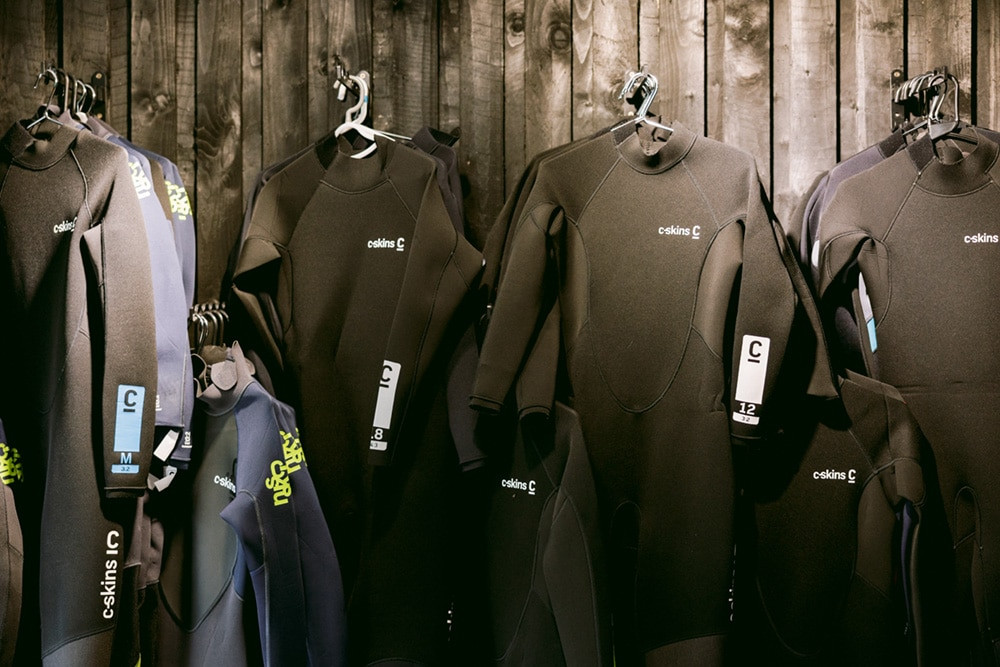 wetsuits hanging up