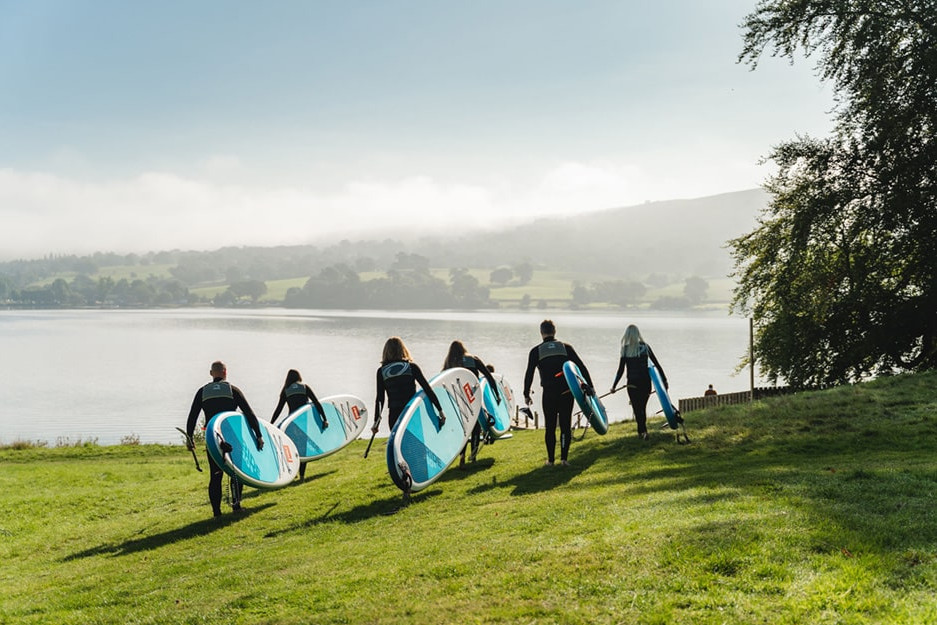 carrying sups down to the lake