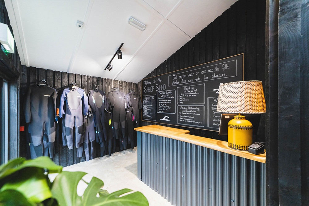    wet suits hanging in the sheep shed